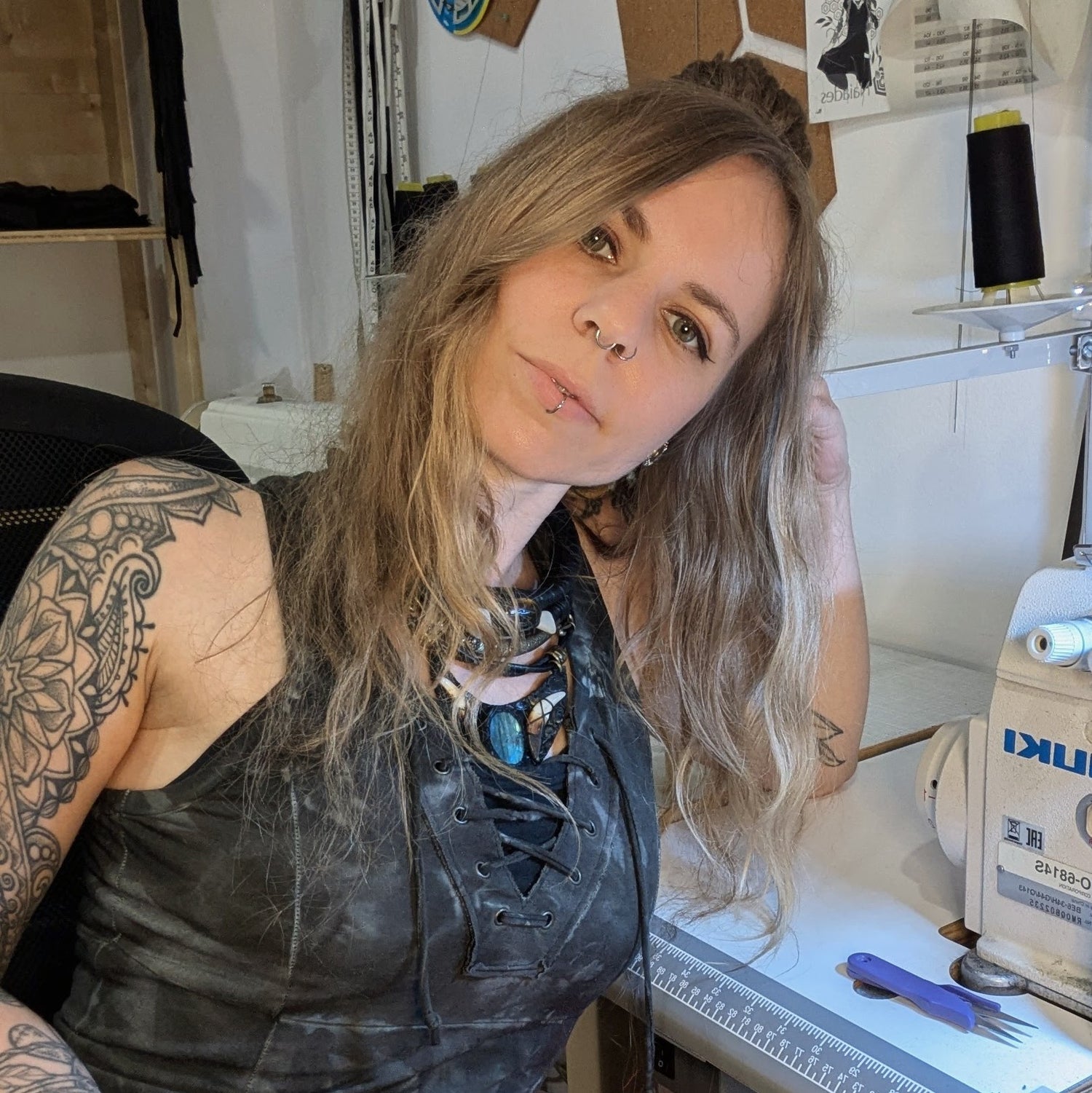 Woman with tattoos in a workshop setting